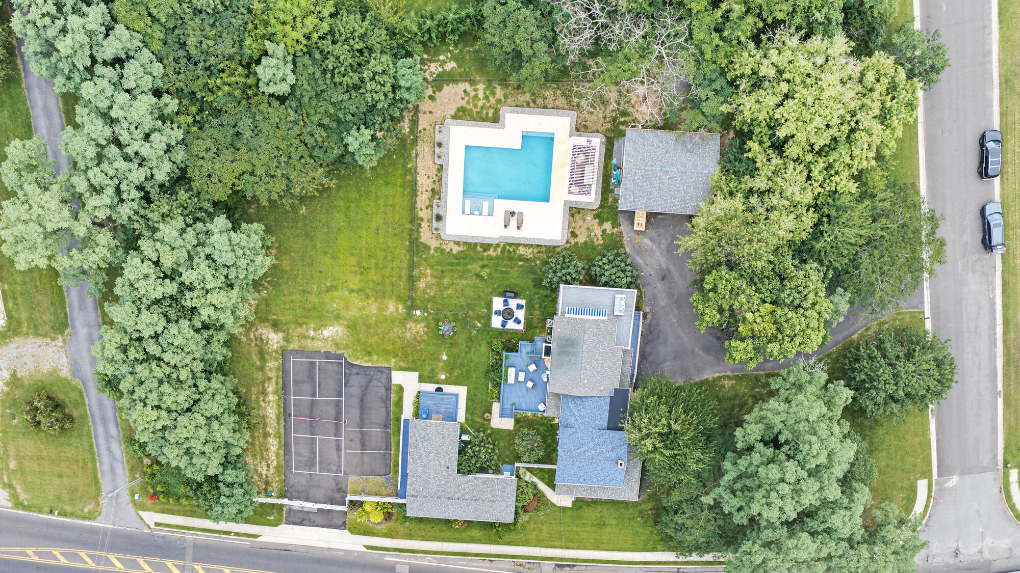 Aerial view of the whole estate: pool, pickleball court, and grounds